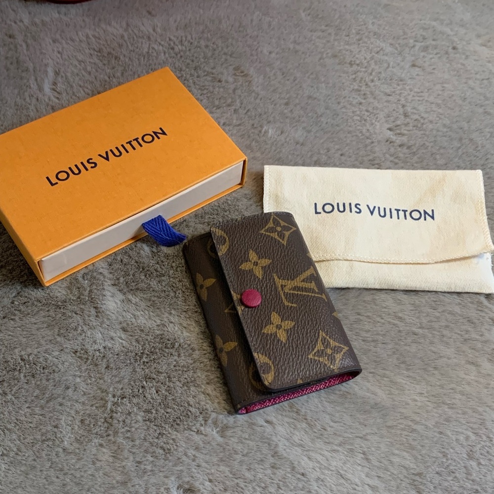Louis Vuitton 6 ring key holder in monogram and magenta interior.